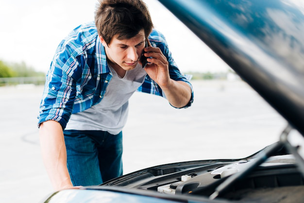 A person making a call to an emergency locksmith for immediate assistance with ignition problems.