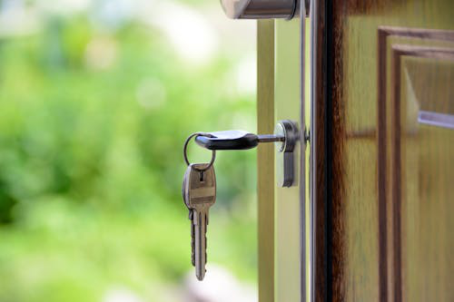 Close-up of house keys inserted into a door lock, symbolizing residential lock repair and maintenance in Las Vegas.