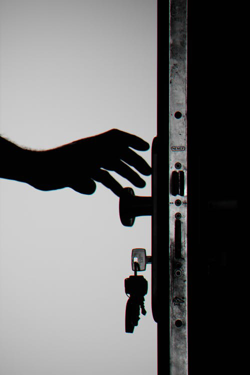 A person reaching for a door handle, symbolizing secure and simplified access with master key systems.