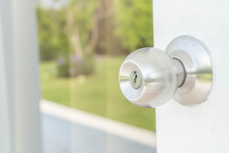 Modern door knob on a residential door representing secured access after professional rekeying.