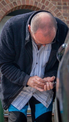 A Locksmith carefully unlocking a car door, demonstrating professional and skilled service.