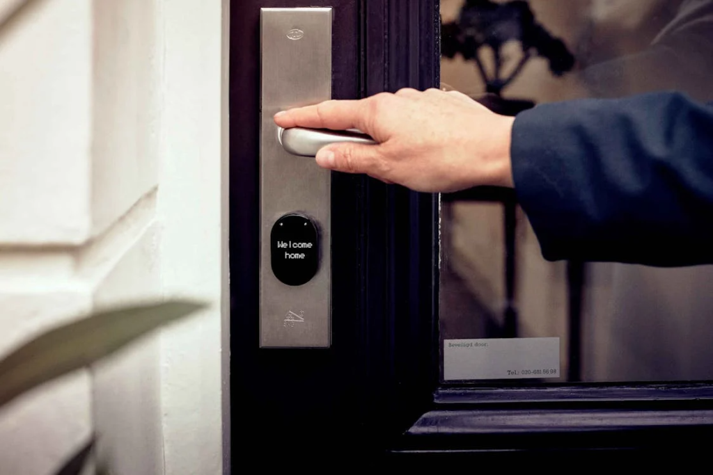 keyless home entry system with a person’s hand on the door handle, presumably for fingerprint sensing.