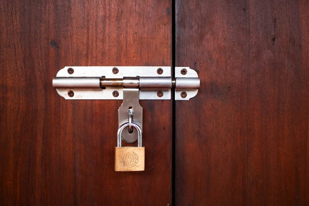 deadbolt lock on  a brown door.