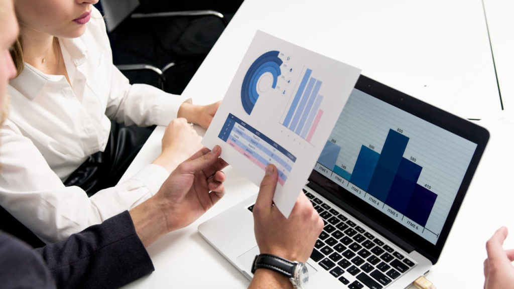 Business professionals analyzing charts and reports to understand the benefits of rekeying for workplace safety.