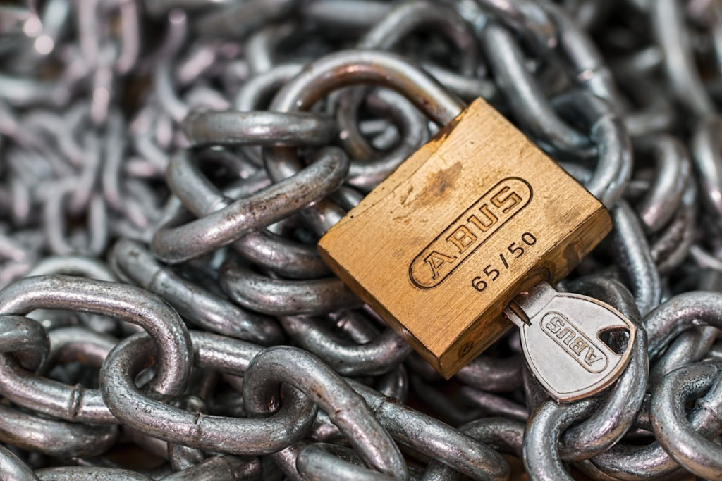  A lock with a key resting on chains.