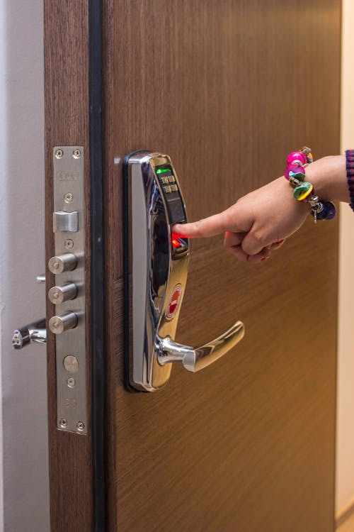Person unlocking a fingerprint-enabled smart lock, one example of advanced systems prone to smart lock issues.