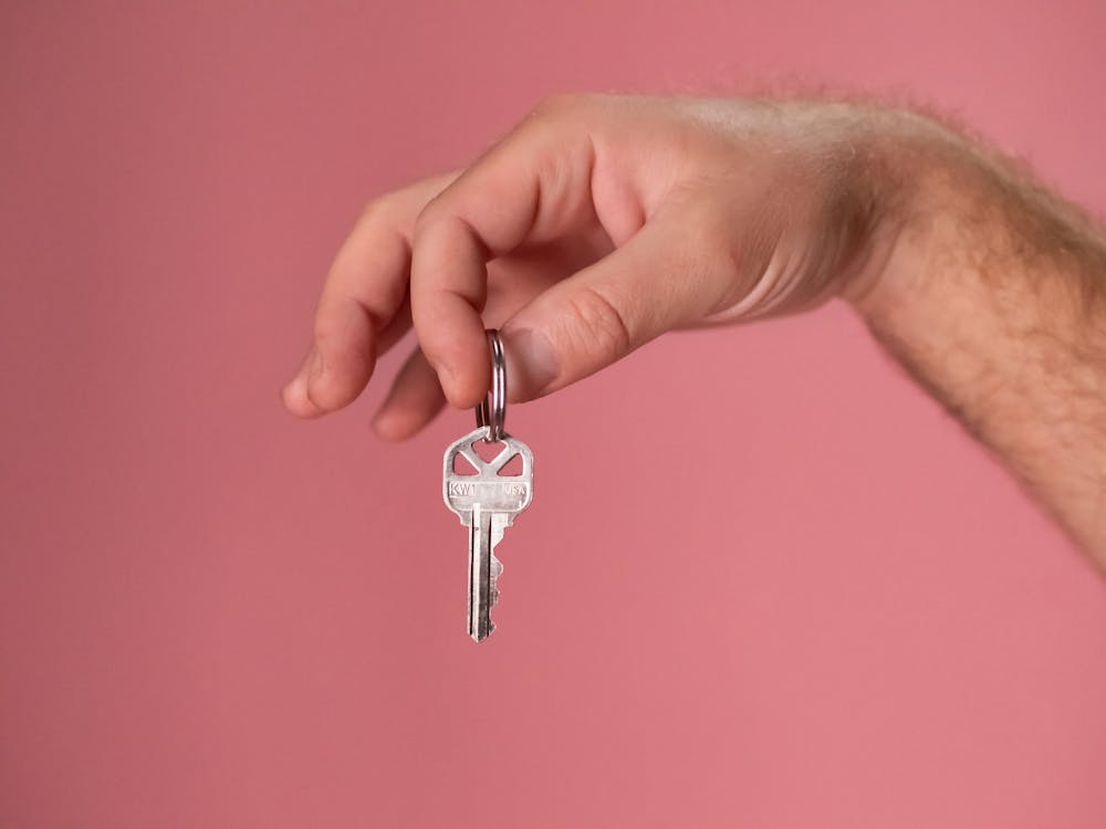 a person holding a silver key 