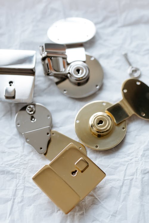 Close-up of silver and gold padlocks.